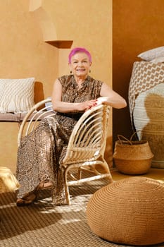 Retired woman sits in lobby of authentic middle eastern style hotel