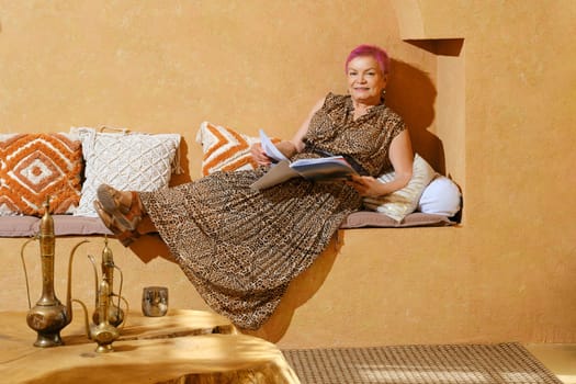 Old woman reading a magazine during trip to Middle East