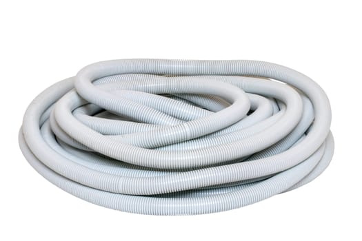 Gray industrial flexible corrugated pipe for installations of electric cable isolated on a white background. Hoses spool of flexible PVC. Macro.