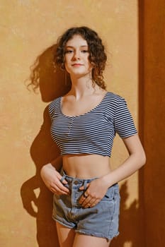 Portrait of beautiful young girl under harsh sunlight