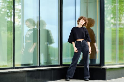 Young teenager model in black clothes outdoors