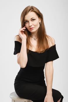 Cute lady in balck dress looking to the camera