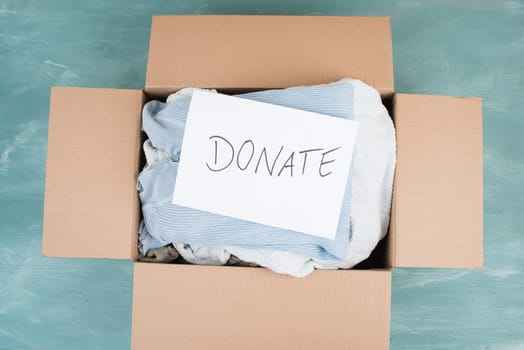 Package with used clothes for donation, second hand use for poor people, welfare and support concept, humanitarian act