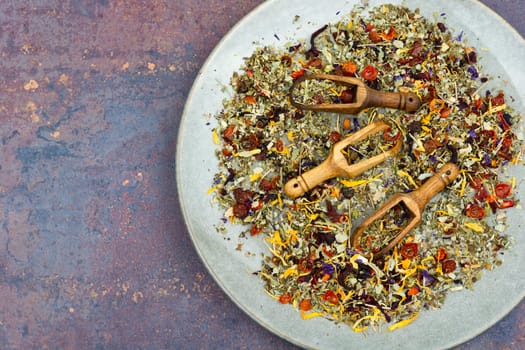 Herbal tea with healthy herbs tea in wooden spoons