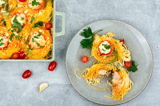 Tasty nest of spaghetti stuffed meatballs and tomato