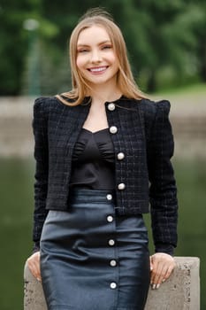 Outdoor portrait of cheerful smiling young woman
