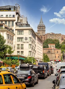Istanbul, Turkey - August 31, 2022: Traffic congestion at Maliye street, or Maliye Caddesi, Karakoy neighbourhood, Beyoglu district, with Galata Tower in the far end