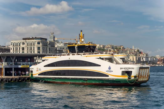 Istanbul, Turkey - September 1, 2022: Small ferry boat docked at Karakoy ferry terminal, in a sunny summer day