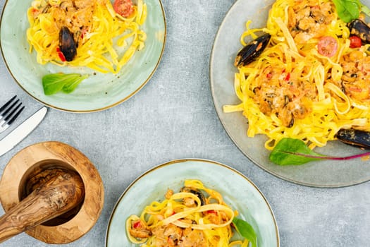 Pasta spaghetti with seafood. Cooking mediterranean food. Light gray background