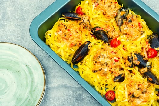 Pasta spaghetti with seafood. Cooking mediterranean food. Light gray background