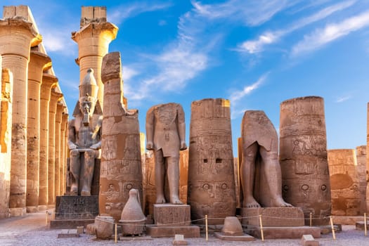 Luxor Temple, first pylon ruins and the statues of Ramses II, Egypt.