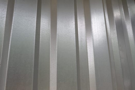 aluminum chrome metal profiled sheet with vertical stripes. metallic gray.