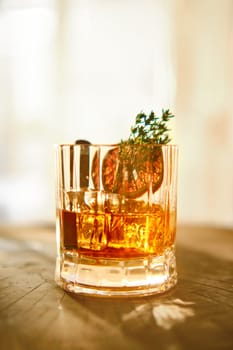 Spicy and sour bourbon and ice sunny cocktail (selective focus photo)