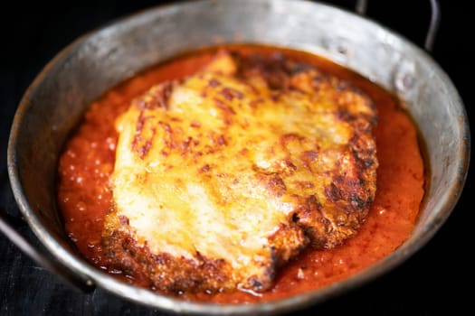 closeup of pan of rustic italian chicken parmesan comfort food