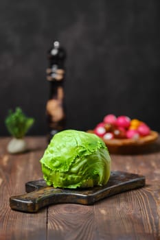 Fresh lettuce on cutting board (photo with shallow depth of field)