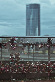 Vertical shot of many love locks on the railing of the Hohenzollern Bridge in Cologne, Germany