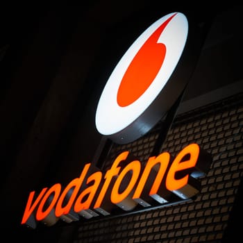 advertisement of the mobile phone provider Vodafone in the city center of Berlin in the evening