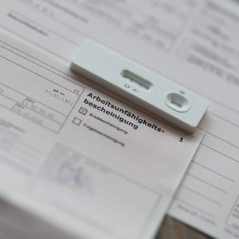 Certificate after a positive Corona test for the employer with the german inscription Arbeitsunfaehigkeitsbescheinigung. Translation: certificate of incapacity for work