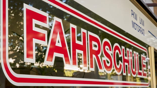 Shop window with German lettering Fahrschule in downtown Berlin. Translation: driving school
