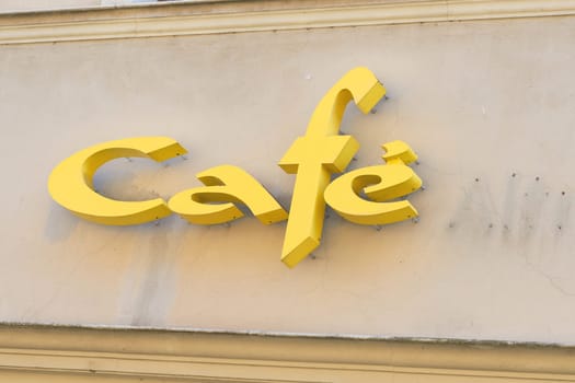 yellow lettering cafe on a facade in the old town of Wittenberg in Germany