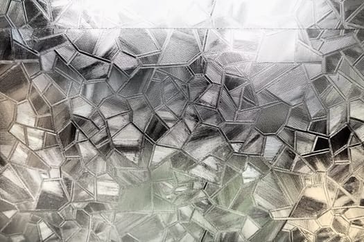 Fluted glass with backlight. Beautiful multicolored refraction of light. Abstract background. Self-adhesive film. Ribbed glass surface. Embossed glass background.