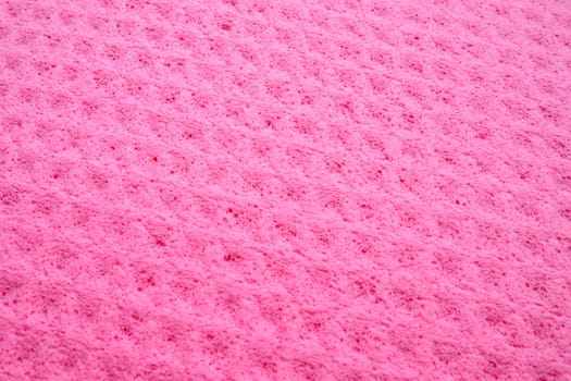Sponge fibers sponge texture pattern surface close-up pink magenta background.