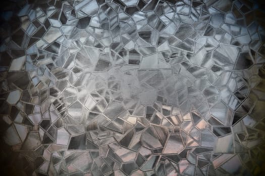 Fluted glass with backlight. Beautiful multicolored refraction of light. Abstract background. Self-adhesive film. Ribbed glass surface. Embossed glass background.