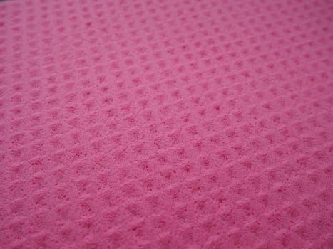 Sponge fibers sponge texture pattern surface close-up pink magenta background.