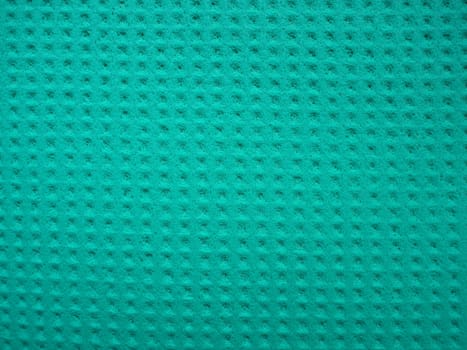 Sponge fibers sponge texture pattern surface close-up green background.