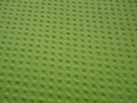 Sponge fibers sponge texture pattern surface close-up green yellow background.