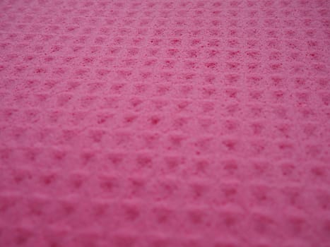 Sponge fibers sponge texture pattern surface close-up pink magenta background.