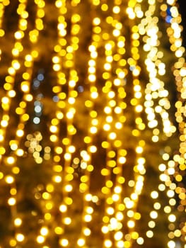 Festive garland. City night light blur bokeh, defocused background. Christmas bokeh. Beautiful lights against the black night sky. Street decoration for New Year and Christmas.