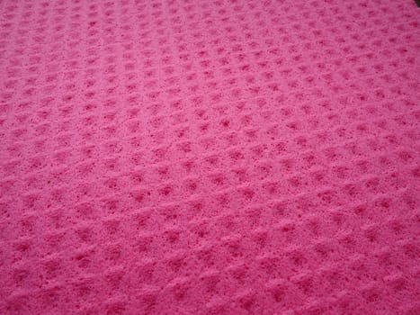 Sponge fibers sponge texture pattern surface close-up pink magenta background.