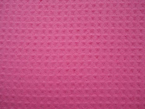 Sponge fibers sponge texture pattern surface close-up pink magenta background.