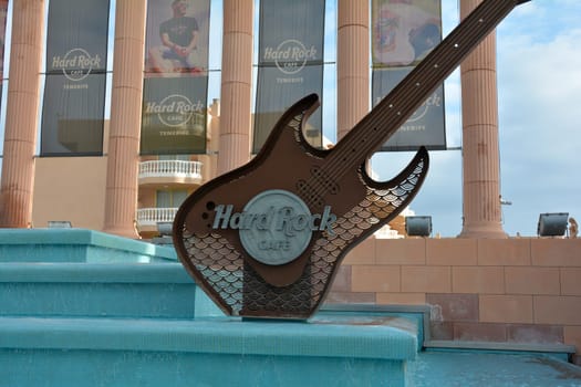 Hard Rock Cafe, Playa de la Americas, Tenerife, Spain August 12, 2022 - Building exterior with a guitar and fountain