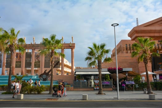 Hard Rock Cafe, Playa de la Americas, Tenerife, Spain August 12, 2022 - View from across the street of the Cafe building with palm trees and sky