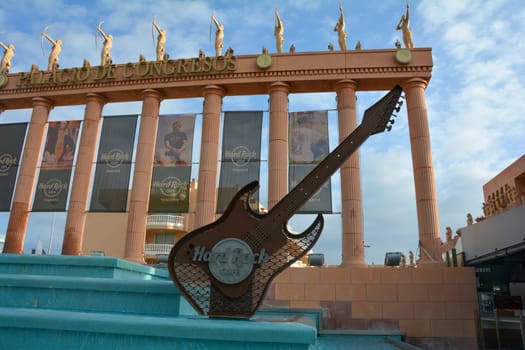 Hard Rock Cafe, Playa de la Americas, Tenerife, Spain August 12, 2022 - Building exterior with guitar , fountain and some archers figure and blue sky