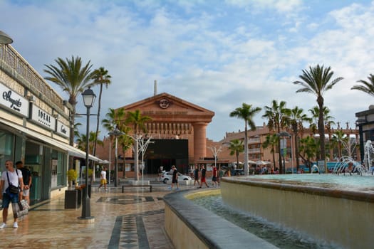 Centro Comercial Safari Shopping Mall, Playa de la Americas, Tenerife, Spain August 12, 2022 - Water fountain overlooking the Hard Rock Cafe with blue sky