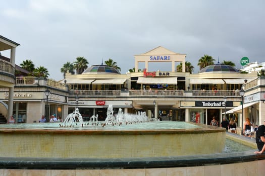 Centro Comercial Safari Shopping Mall, Playa de la Americas, Tenerife, Spain August 12, 2022 - Water fountain and shopping mall and blue sky