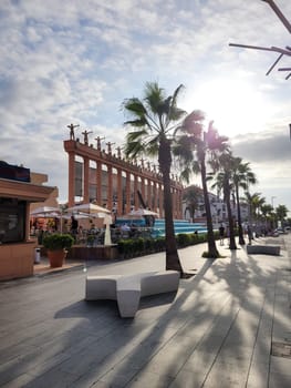 Hard Rock Cafe, Playa de la Americas, Tenerife, Spain August 12, 2022 - Building exterior with guitar, fountain and some archers stone figure, palm tree and sun