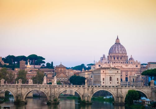 ROME, ITALY - JUNE 2020: sunset panorama on Tiber river bridge with Saint Peter Cathedral dome (Vatican City) in background - Rome, Italy