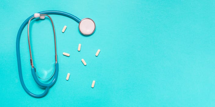 Medicine debate concept. Biotechnology banner with medical stethoscope and pills. Copy space for text. flatlay.