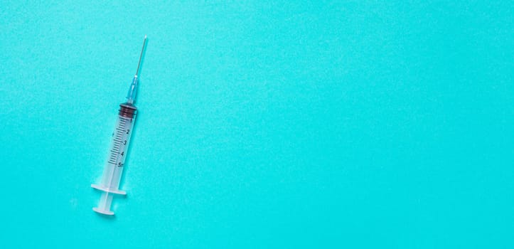 Vaccination debate concept. Biotechnology banner with medical syringe. Copyspace for text. flatlay.