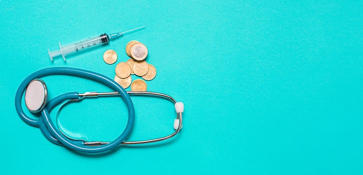 Concept of scientific research in medicine. Biotechnology banner with medical syringe stethoscope and money. Copyspace for text. flatlay.