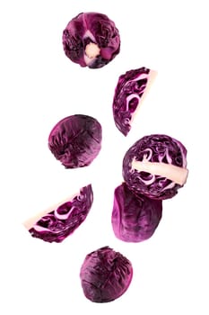 Isolated flying vegetables. Seven whole and sliced red chicory falling on white with clipping path as package design element and advertising. Full depth of field.