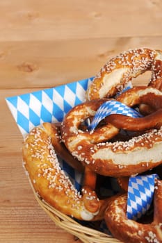 original Bavarian lye pretzels with salt in a basket on wooden boards