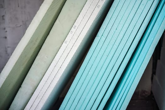 Foam polystyrene insulation boards ready for installation at new house construction, closeup detail.