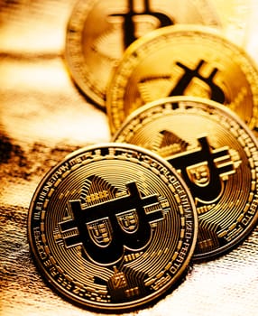 Closeup of golden bitcoin BTC cryptocurrency over black and gold background. Virtual money and blockchain concept.