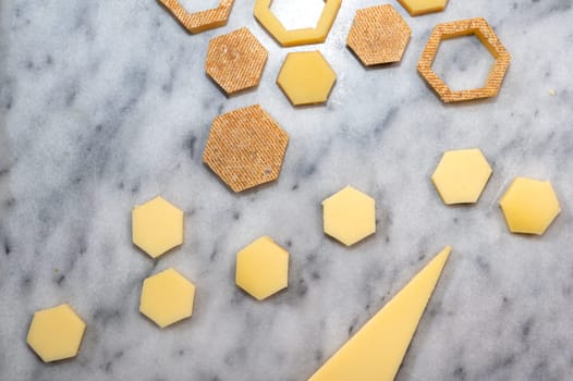 funny tasted pieces of cheese for lunch or apperitive on a marble table