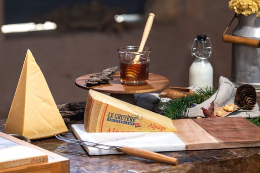 July 12 2022, Lyon, France : Tasted famous swiss cheese : Le Gruyère d'Alpage with milk and honey for lunch and food experience